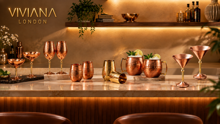 Styled luxury home bar setup featuring handcrafted hammered copper martini glasses and wine stems