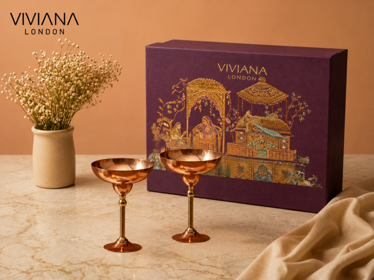 Handcrafted pure copper martini glasses and Mughlai copper jug displayed on a marble bar cart for luxury gifting