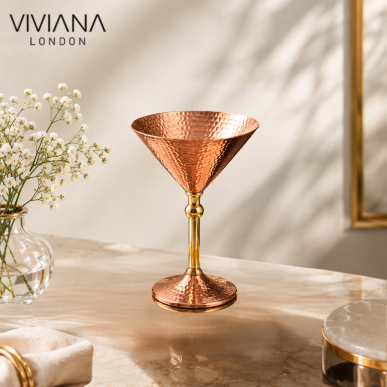 Handcrafted pure copper martini glass with frosted exterior on a marble bar cart next to mixology tools