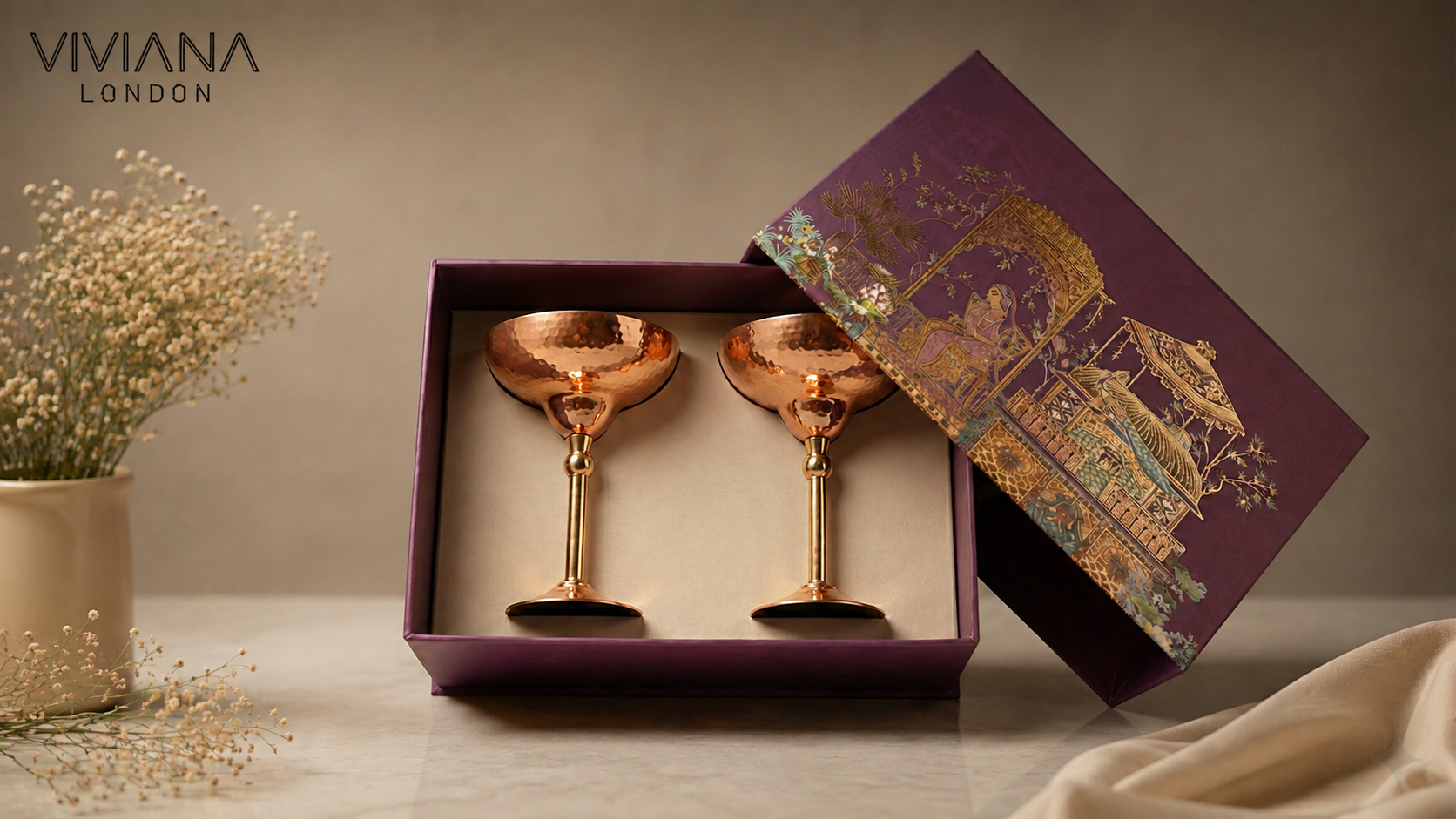Handcrafted pure copper martini glasses and Mughlai copper jug displayed on a marble bar cart for luxury gifting