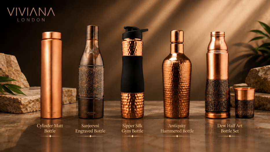 Handcrafted pure copper water bottle set styled on a dark marble desk next to a filled water tumbler